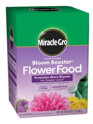 Purple and green box of Miracle-Gro flower food with floral images and a watering can.