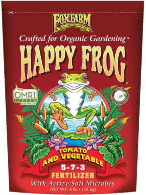 Red fertilizer bag with a frog, plants, and text for organic gardening.