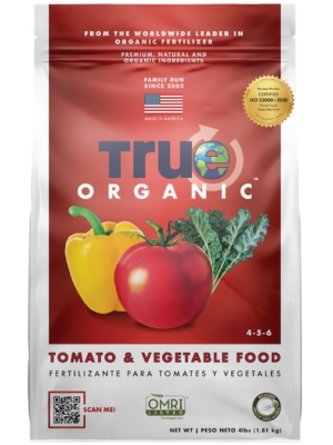 White bag of fertilizer featuring red tomato and yellow bell pepper illustrations, labeled "True Organic."