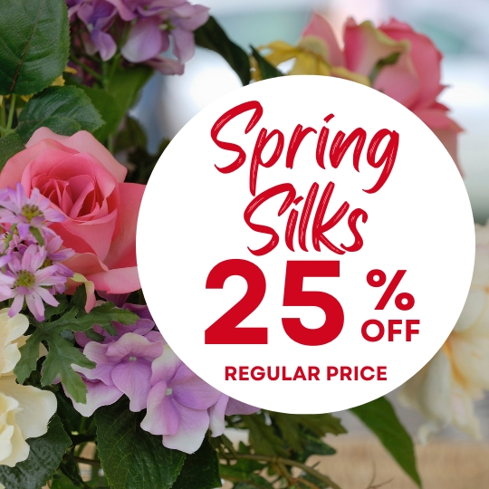 Close-up of assorted artificial spring flowers with a white circle overlay announcing "Spring Silks 25% Off Regular Price" in red text.